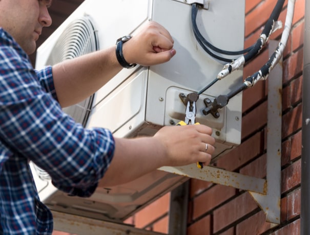 A technician repairs an outdoor ductless air conditioner in Danville, IN.